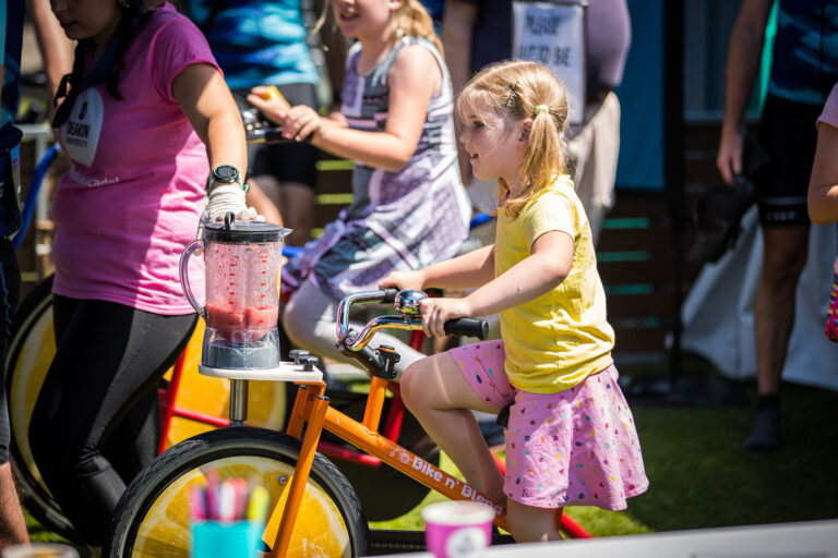 Child having fun on a bike on fundraisers' school event