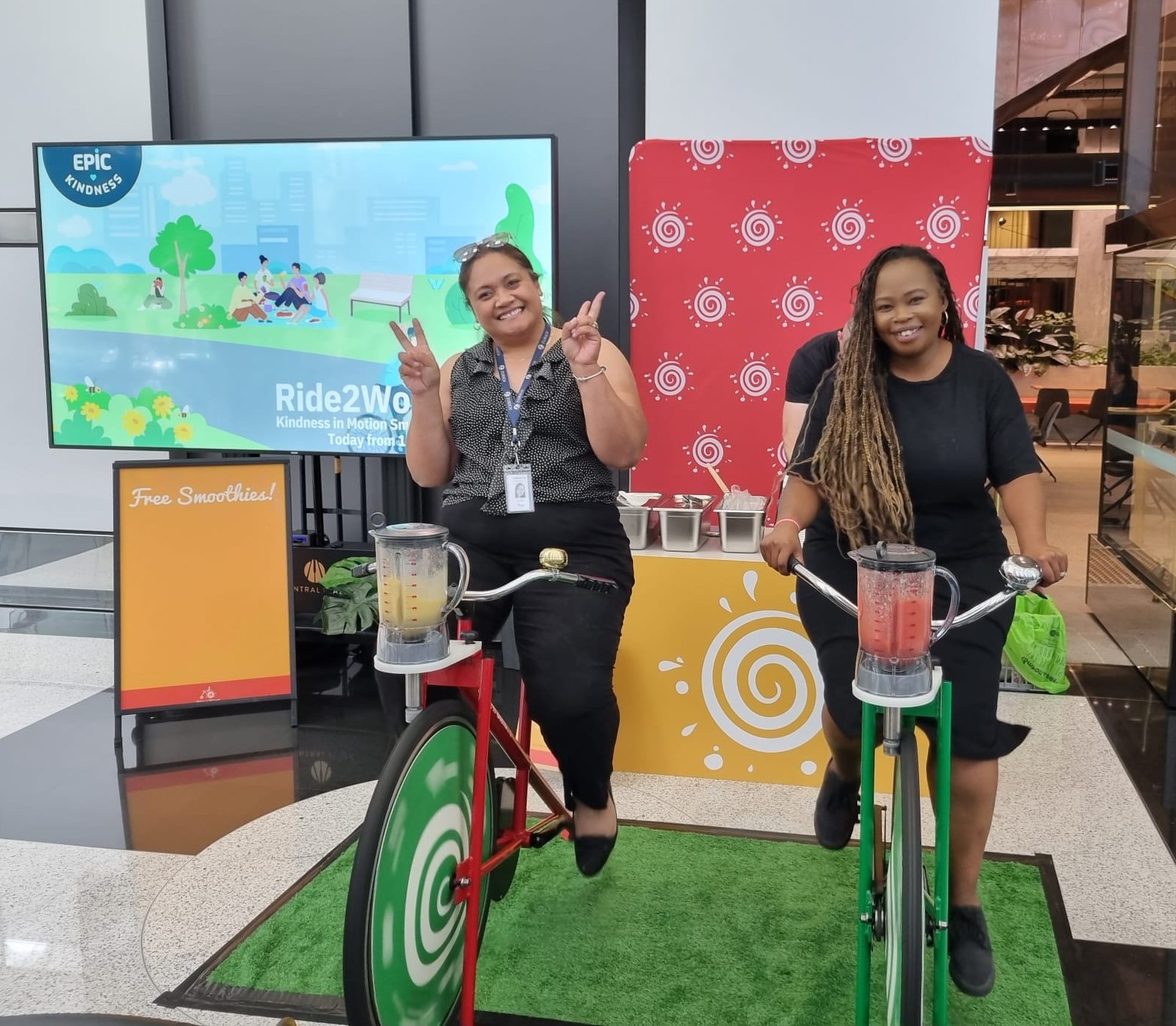Ride to Work Day - Smiling employees pedalling for smoothies