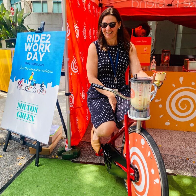 woman laughing at Ride 2 Work Day event while making a smoothie