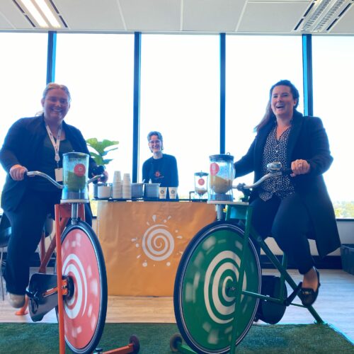 happy team on bike n blend's smoothie bikes during a corporate event