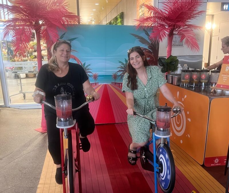 Shopping centre activity ideas: two people on smoothie bikes during a bike n blend pop-up event