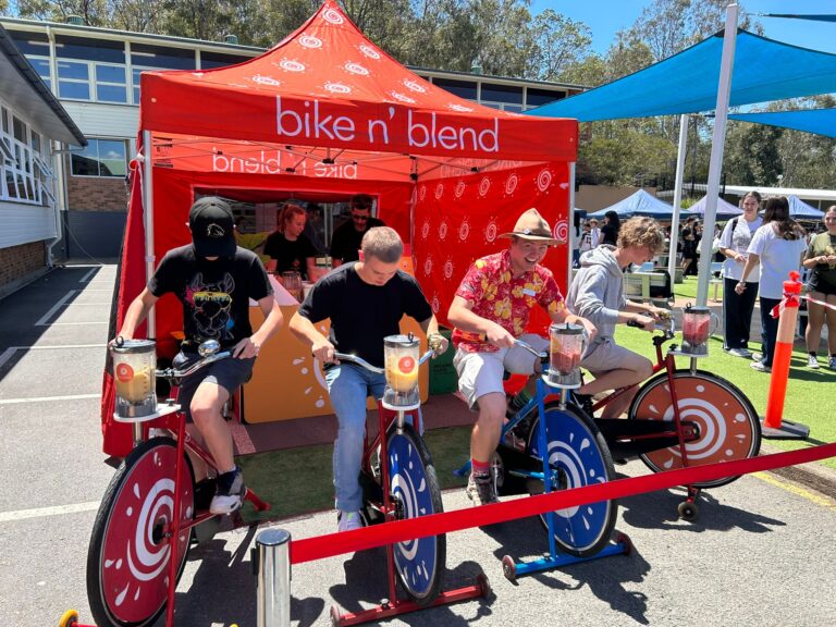 smiling group on bike n blend smoothie bikes - council festival
